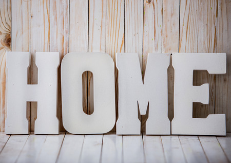 A portrait of white HOME sign on wooden backgroundの写真素材