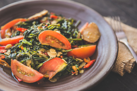A portrait of Kale and tomato stir-fry, close up