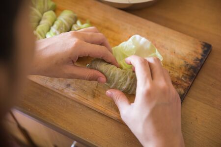 A portrait of processing to make a meat wrap in cabbage. cabbage roll recipeの写真素材