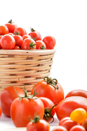portrait of tomatoes and cherry tomatoes isolated on white backgroundの写真素材