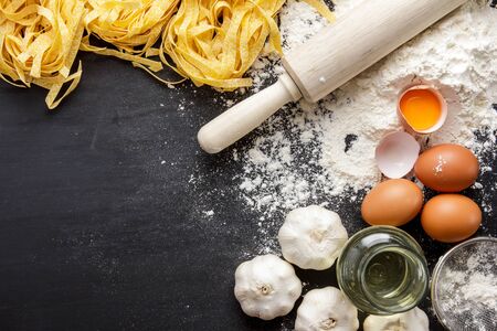 raw homemade italian fettucine and ingredients with copy spaceの写真素材