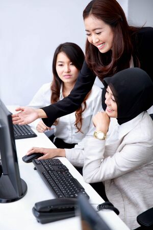 beautiful businesswoman explaining about job to her co-worker at officeの写真素材