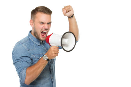 portrait of young man screan througout a megaphone . isolated over white backgroundの写真素材