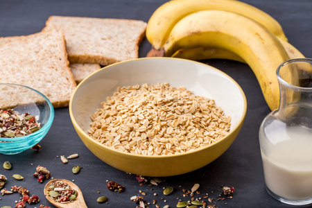 portrait of healthy oatmeal with ingredients for breakfast on black boardの写真素材