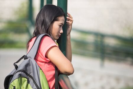 A portrait of a young Asian student feel sad, thinking about her futureの写真素材