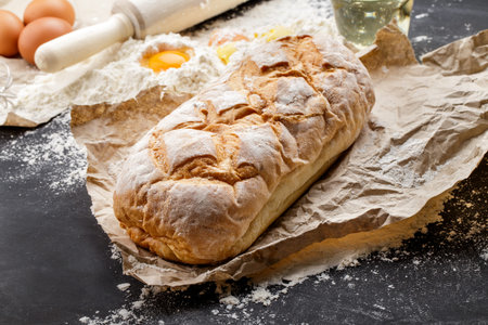 full frame of homemade rustic bread on black board