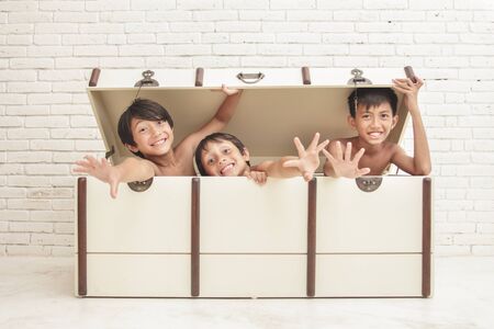 portrait of expression of three cheerful brothers inside the crateの写真素材