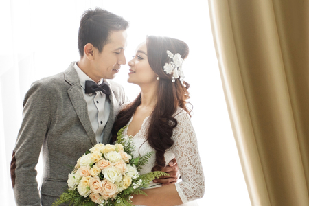 close up portrait of romantic asian newlywed coupleの写真素材