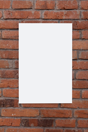portrait of blank white board on brick wallの写真素材