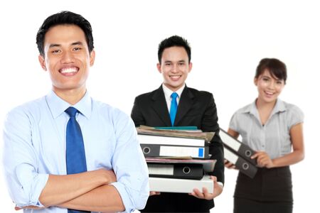A portrait of a young asian businessman, with his team behind. isolated in white backgroundの写真素材