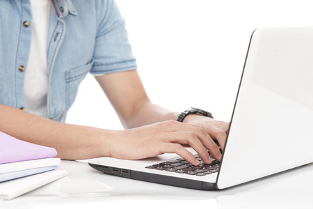 close up portrait of man typing on a laptop isolated on white background