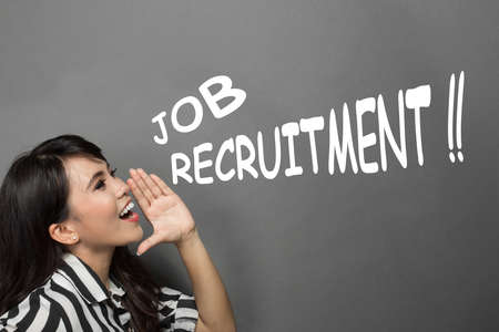 portrait of a young businesswoman shoutting about job recruitmentの写真素材