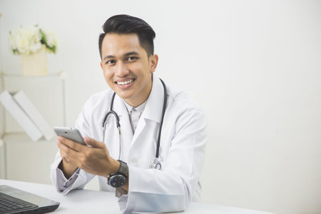 portrait of Concentrated doctor with tablet in his clinic