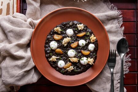 top view portrait of a plate of black squid risottoの写真素材