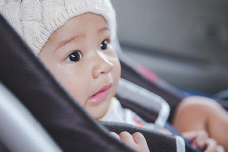 portrait of a baby in a safety car seat. Safety and securityの写真素材