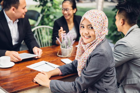 Attractive asian businesswoman smiling at the camera during a business meetingの写真素材