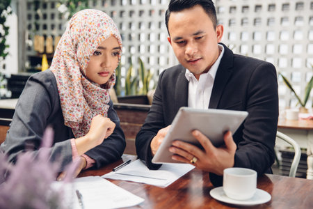 Business adviser analyzing financial figures of the company while meeting