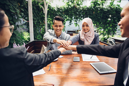 close up of business team showing unity with their hands togetherの写真素材