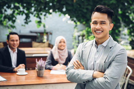 portrait of asian Businessman leader on the foreground of his teamの写真素材