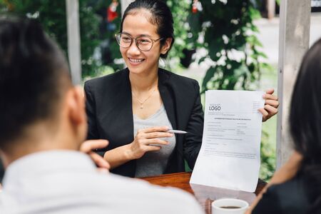 portrait of young asian businesswoman doing presentation while meeting in a cafeの写真素材