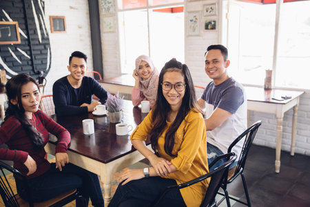 portrait of friends having fun together in a cafe. looking at camera