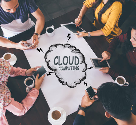 top view of friends at a cafe with all people busy with their own digital devices. cloud cumputing...