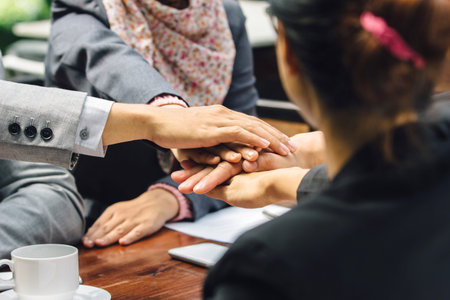 close up of business team showing unity with their hands together