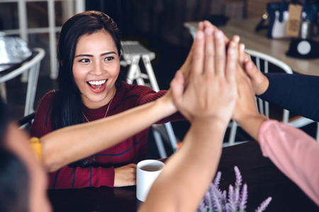 portrait of young enthusiastic team giving high fiveの写真素材