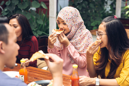 Group Of Young Friends Enjoying Meal In Outdoor Restaurantの写真素材