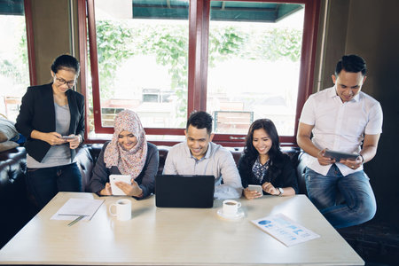 portrait of business people busy with their own gadget