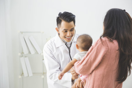 portrait of a baby being checked by a doctor using a stethoscope