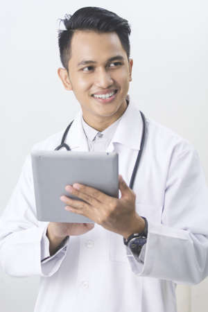 portrait of smiling doctor with tablet pcの写真素材