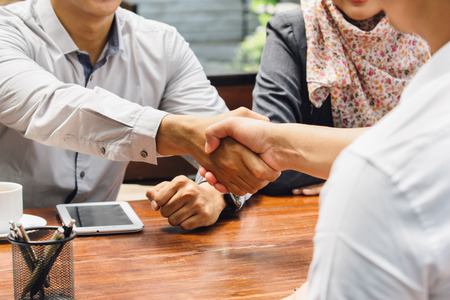 portrait of Business people shaking hands while meeting at the officeの写真素材