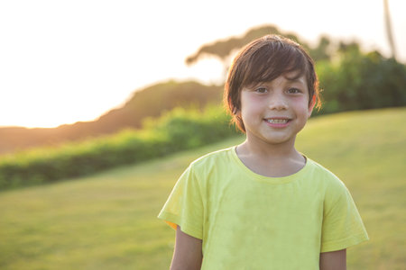 portrait of happy boy smiling to the camera in the park