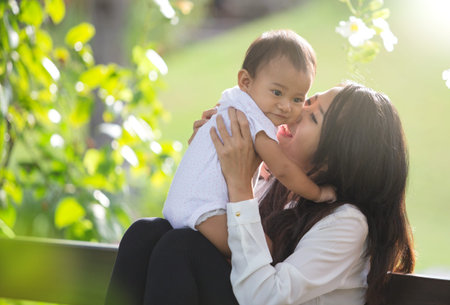 portrait of Beauty Mother and her Child playing in Park together