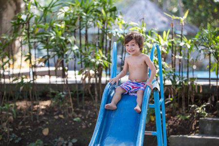 portrait of Kids, playing on the playground, having fun sliding