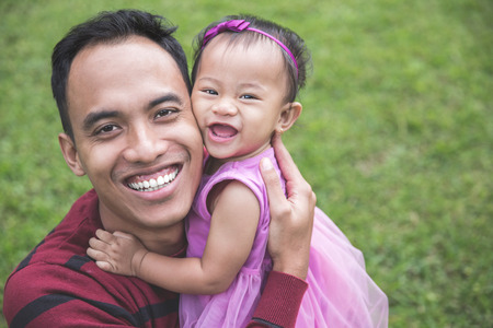 portrait of Happy young father with little daughter outdoorsの写真素材