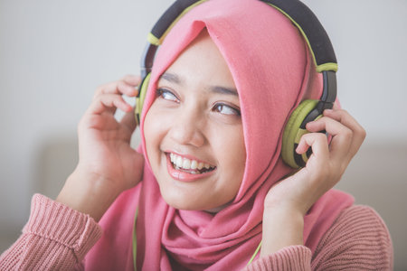 portrait of beautiful asian woman enjoying music