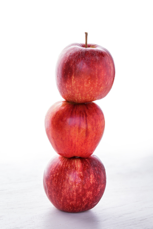portrait of stack of fresh red apple isolated on white backgroundの写真素材