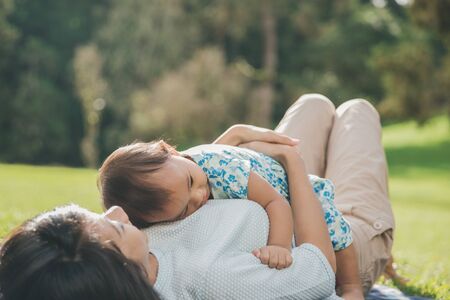 Lifestyle portrait mom and daughter in happines at the outside in the meadowの写真素材