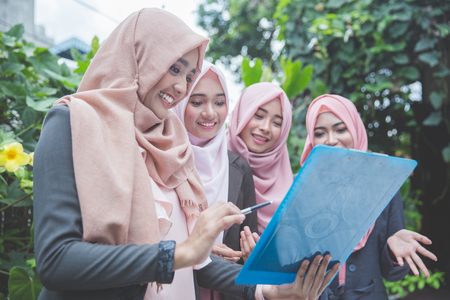 group of four young muslim businesswoman having a meeting outdoorの写真素材