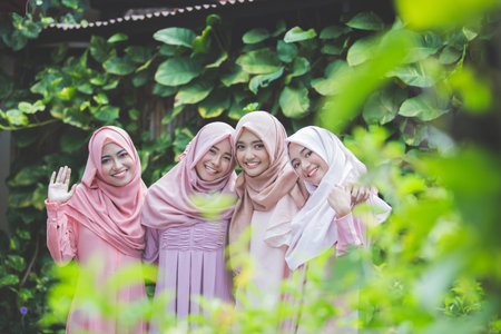 portrait of happy group of pretty girl best friends together. muslim woman concept wearing hijab or head scarfの写真素材