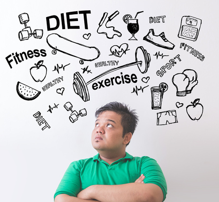 Portrait of Fat asian man thinking and looking up. Diet conceptの写真素材