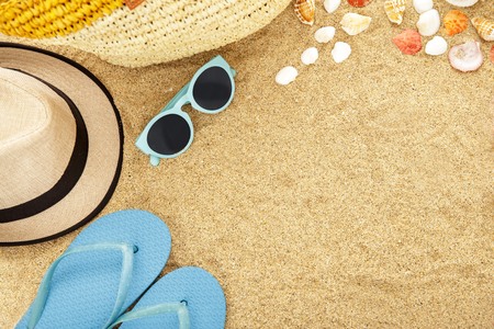 top view portrait of beach accesories on sands with spaceの写真素材