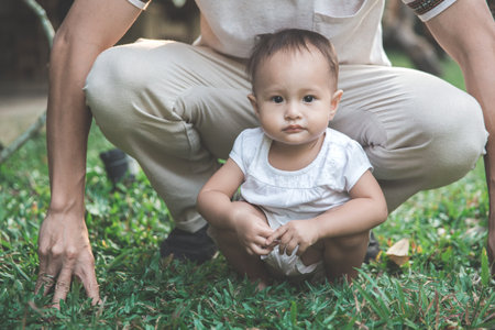 Father with his baby have fun in the parkの写真素材