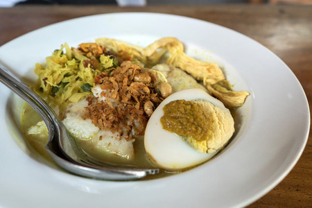 tipat sayur. indonesian traditional food. rice cake and egg with coconut milk soup and chickenの写真素材