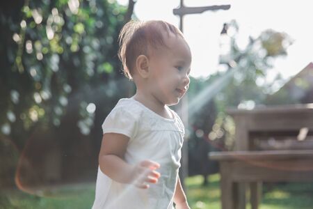 portrait of young toddler running in the parkの写真素材