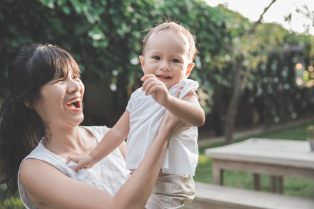 portrait of happy mother and her baby have fun in the garden