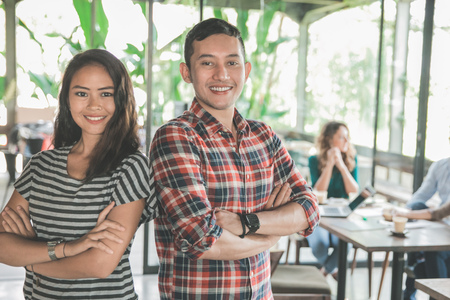 portrait of mixed race two young partner during their meeting in cafeの写真素材