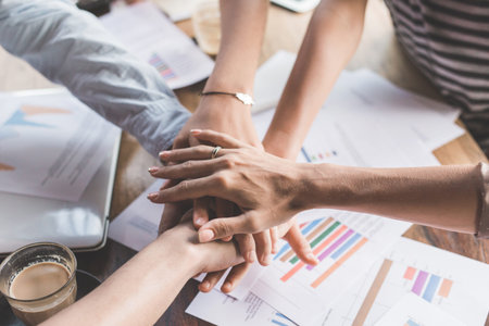 close up of business team showing unity with their hands together